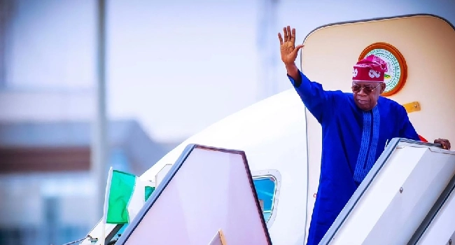 President-Bola-Tinubu-waving-on-an-airplane
